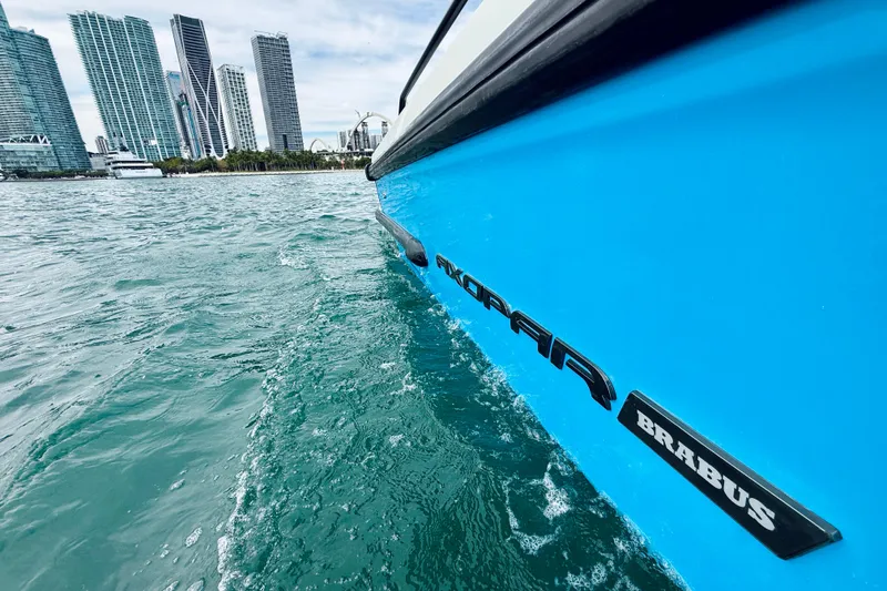 Slide: The Image of 2021 Axopar 37 Sun Top boat cruising near city skyline. - 59