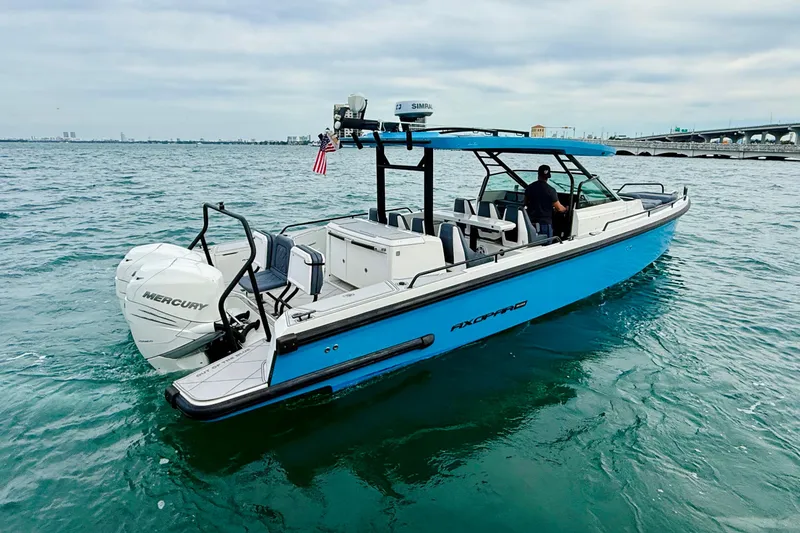 Slide: The Image of 2021 Axopar 37 Sun Top boat cruising on open water with Mercury engines. - 6