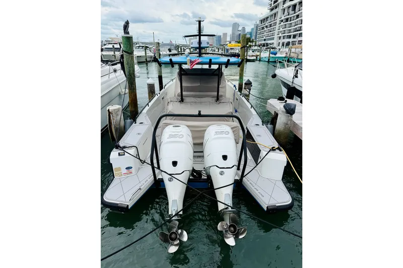Slide: The Image of 2023 Axopar 37 Sun Top boat docked with dual outboard engines. - 65