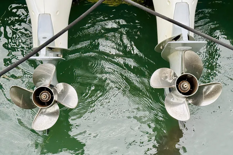 Slide: The Image of Twin propellers of 2023 Axopar 37 Sun Top boat in green water. - 67