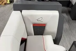 Slide: The Image of 2026 Qwest C-Class 14 Cruise boat interior with modern seating design and logo detail. - 3
