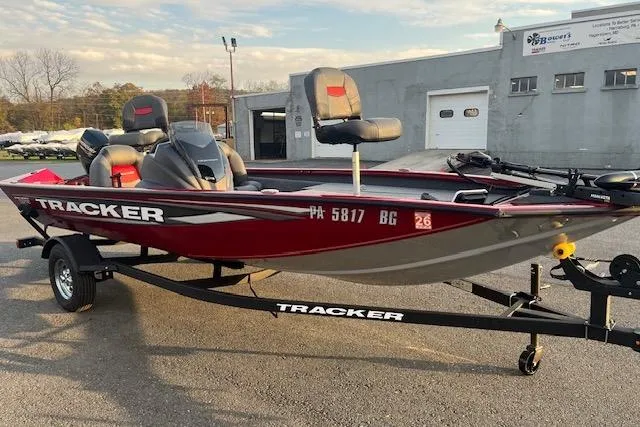 Slide: The Image of 2025 Tracker Pro Team 175 boat on trailer, parked outdoors, featuring red and gray design. - 10