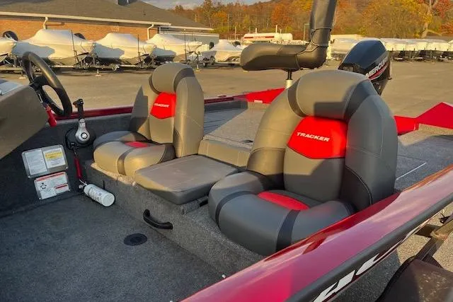 Slide: The Image of 2025 Tracker Pro Team 175 boat interior with gray and red seating. - 8