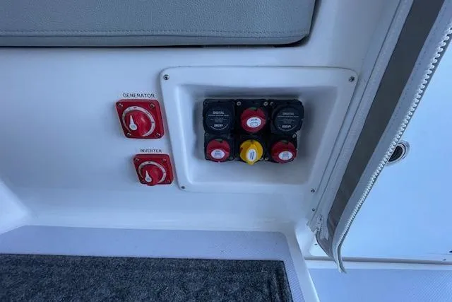 Slide: The Image of Control panel of 2023 NorthCoast 315 boat with thruster and trim tab switches. - 11