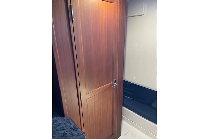 Slide: The Image of 2023 NorthCoast 315 boat interior with white seating and wooden cabinetry. - 17