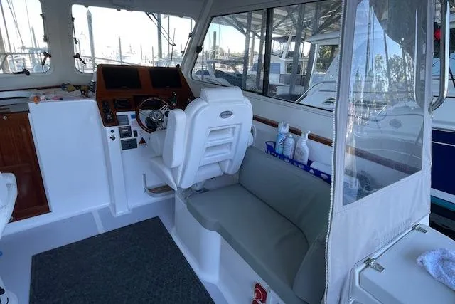 Slide: The Image of 2023 NorthCoast 315 boat docked in a marina under a covered area. - 2