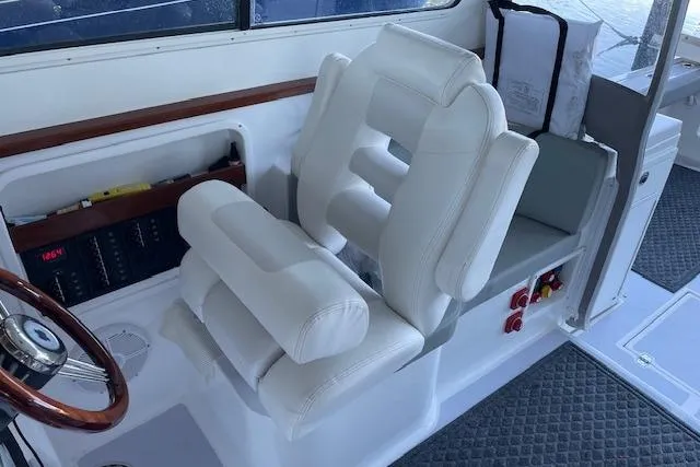 Slide: The Image of 2023 NorthCoast 315 boat interior with wooden steps and storage area. - 20