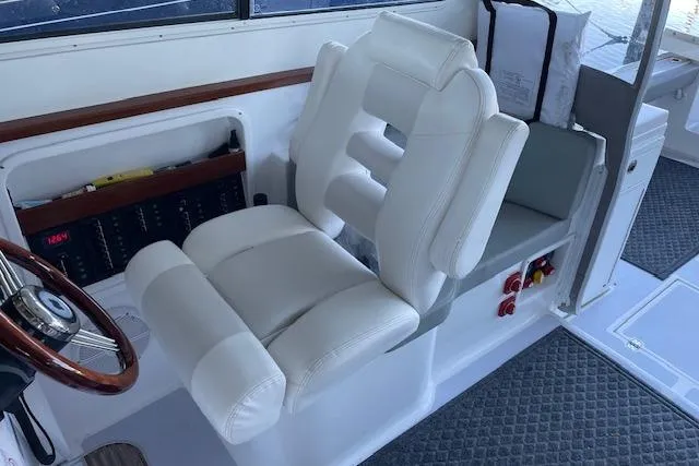 Slide: The Image of Luxury helm seat on 2023 NorthCoast 315 boat, featuring white upholstery and modern design. - 25