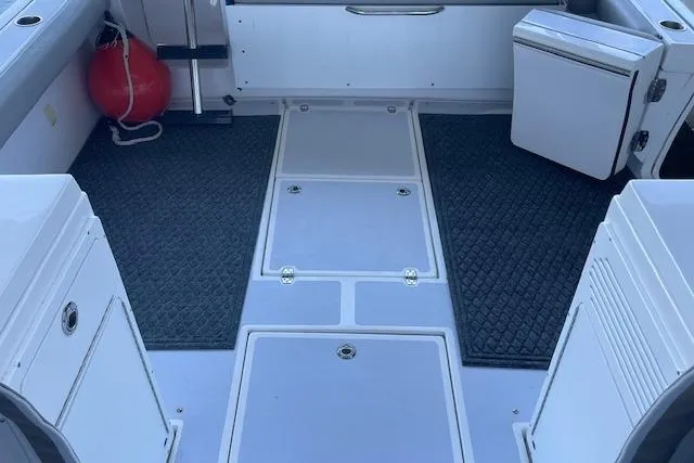 Slide: The Image of Luxurious white seating in 2023 NorthCoast 315 boat interior, featuring modern design and controls. - 26