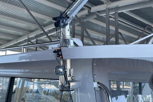 Slide: The Image of 2023 NorthCoast 315 boat deck with seating and storage, docked by the water. - 31