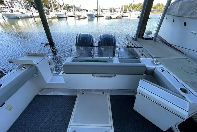 Slide: The Image of 2023 NorthCoast 315 boat with dual engines docked at a marina. - 32