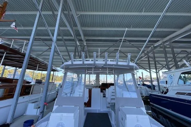 Slide: The Image of 2023 NorthCoast 315 boat docked in a covered marina. - 38