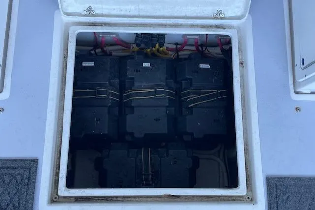 Slide: The Image of Battery compartment of 2023 NorthCoast 315 boat, showing three batteries and wiring. - 39