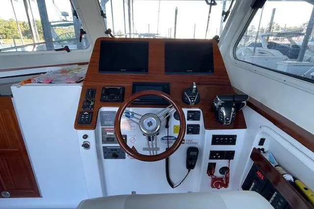 Slide: The Image of 2023 NorthCoast 315 boat docked in marina, front view. - 4