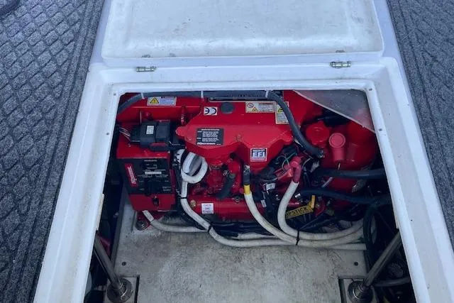 Slide: The Image of Engine compartment of 2023 NorthCoast 315 boat, featuring a red engine and wiring. - 40
