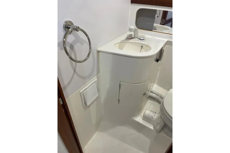 Slide: The Image of 2023 NorthCoast 315 boat bathroom with sink, mirror, and toilet. - 44
