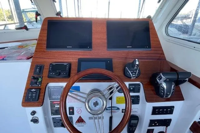 Slide: The Image of 2023 NorthCoast 315 boat docked with twin Yamaha 300 engines. - 5