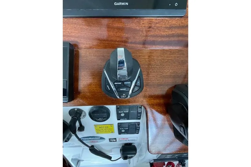 Slide: The Image of 2023 NorthCoast 315 boat helm with dual screens and wooden steering wheel. - 8