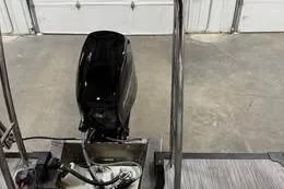 Slide: The Image of 2026 Qwest C-Class 18 Cruise boat engine in a garage setting. - 2