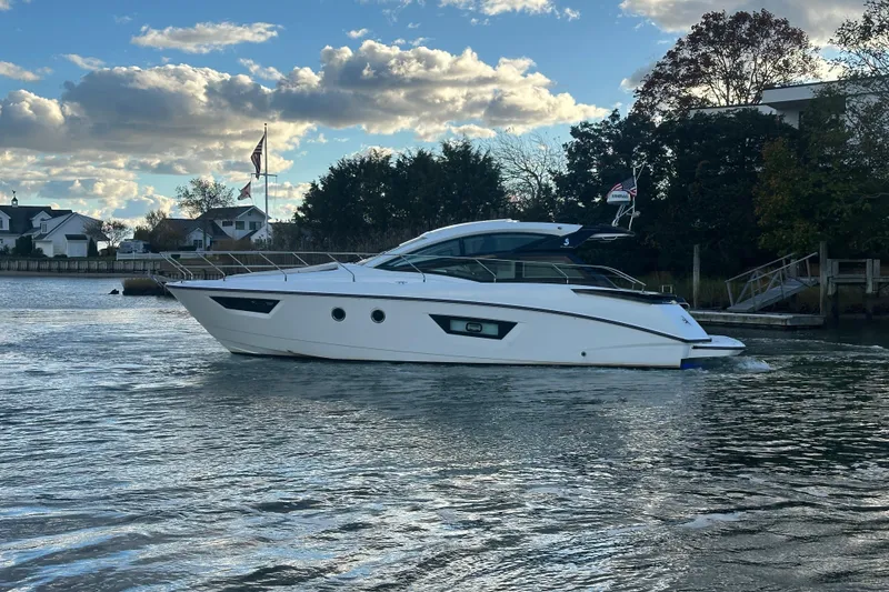 The Image of 2019 Beneteau Gran Turismo 40 yacht cruising on a scenic waterway. - 0