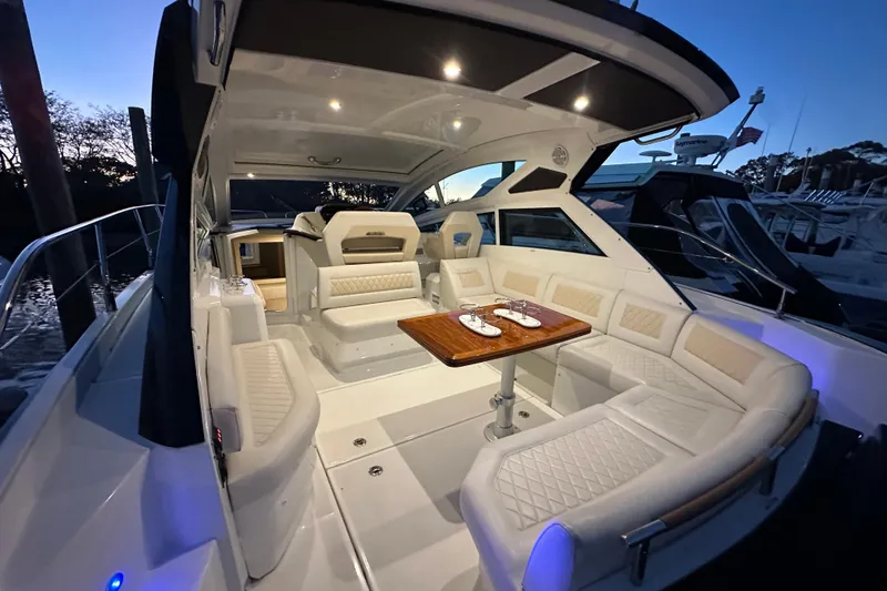 Slide: The Image of Luxurious 2019 Beneteau Gran Turismo 40 yacht interior with elegant seating and dining area. - 11