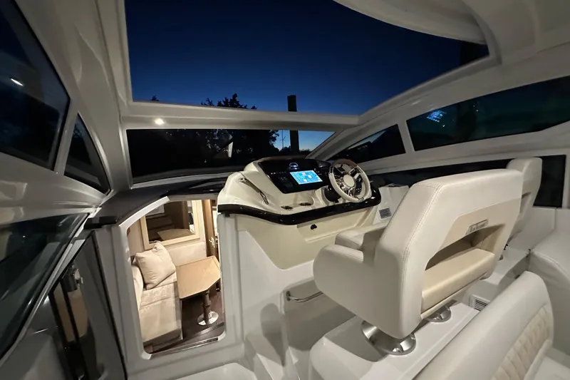 Slide: The Image of 2019 Beneteau Gran Turismo 40 cockpit at dusk, featuring modern helm and luxurious interior. - 19
