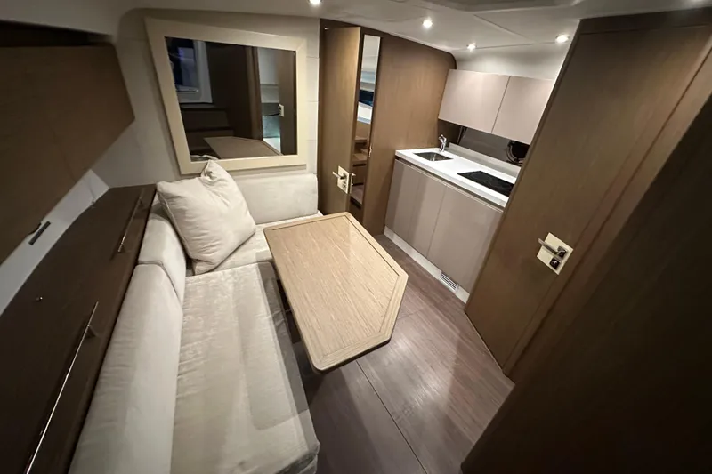 Slide: The Image of Interior of 2019 Beneteau Gran Turismo 40 yacht, featuring modern kitchen and cozy seating area. - 25
