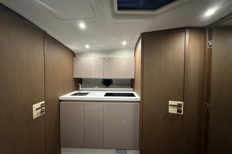 Slide: The Image of 2019 Beneteau Gran Turismo 40 yacht interior kitchen with modern cabinetry and lighting. - 27