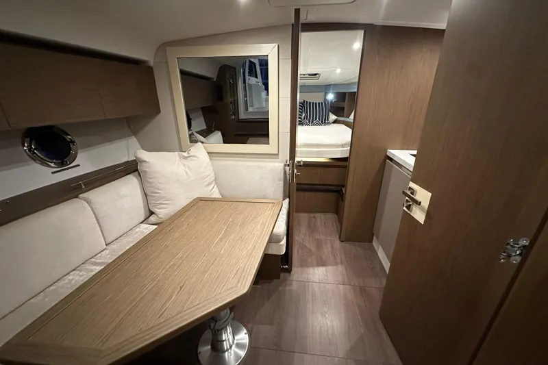 Slide: The Image of Luxurious interior of 2019 Beneteau Gran Turismo 40 yacht with cozy seating and elegant wood finishes. - 35