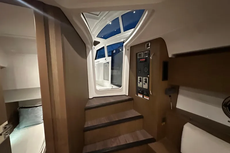 Slide: The Image of Interior view of 2019 Beneteau Gran Turismo 40 yacht, featuring stairs and control panel. - 36