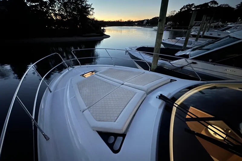 Slide: The Image of 2019 Beneteau Gran Turismo 40 yacht at sunset, docked in a serene marina. - 40