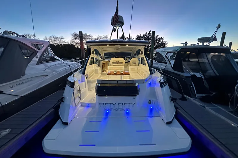 Slide: The Image of 2019 Beneteau Gran Turismo 40 yacht docked at sunset with illuminated deck. - 8