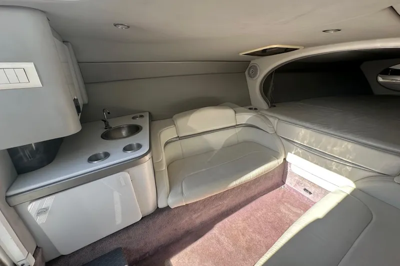 Slide: The Image of 2004 Formula 292 FASTech cabin interior with seating, sink, and compact kitchenette. - 16