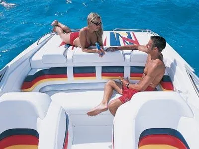 Slide: The Image of 2004 Formula 292 FASTech boat with sleek design and vibrant stripes on calm water. - 3