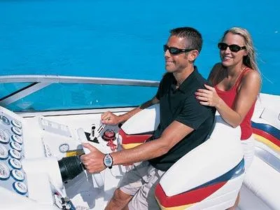 Slide: The Image of 2004 Formula 292 FASTech speedboat docked in a marina, surrounded by sailboats. - 5