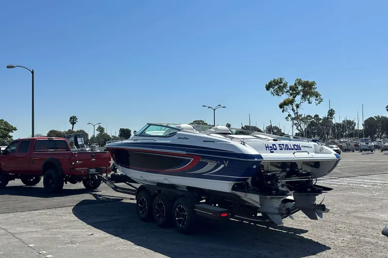 Slide: The Image of 2004 Formula 292 FASTech boat with "H2O Stallion" branding, docked at marina. - 7