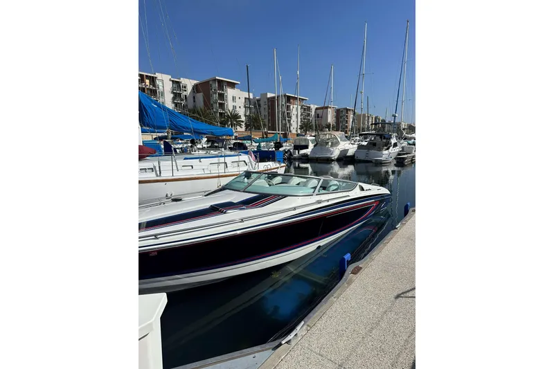 Slide: The Image of 2004 Formula 292 FASTech boat interior with white seating and control dashboard at marina. - 9