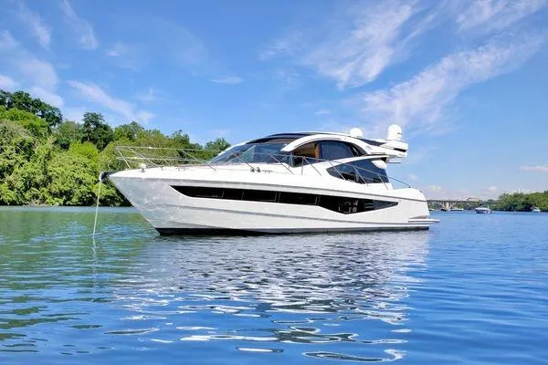 The Image of 2017 Galeon 560 Sky yacht on serene water with clear blue sky. - 0
