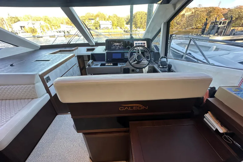 Slide: The Image of Interior of 2017 Galeon 560 Sky yacht with modern helm and luxurious seating. - 12
