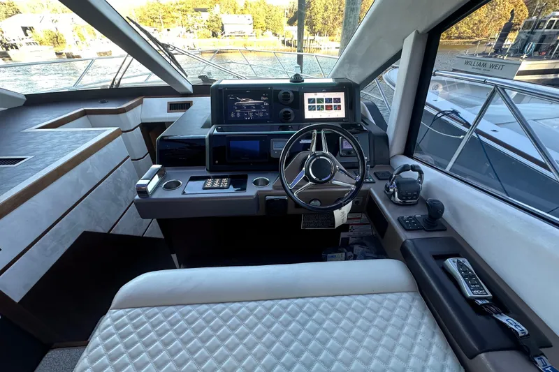 Slide: The Image of Helm of 2017 Galeon 560 Sky yacht with modern navigation equipment and luxurious seating. - 14