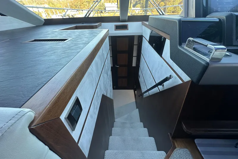 Slide: The Image of Interior staircase of 2017 Galeon 560 Sky yacht, featuring modern design and wood accents. - 15