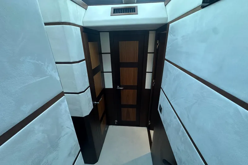 Slide: The Image of Interior hallway of 2017 Galeon 560 Sky yacht with modern wood paneling. - 17