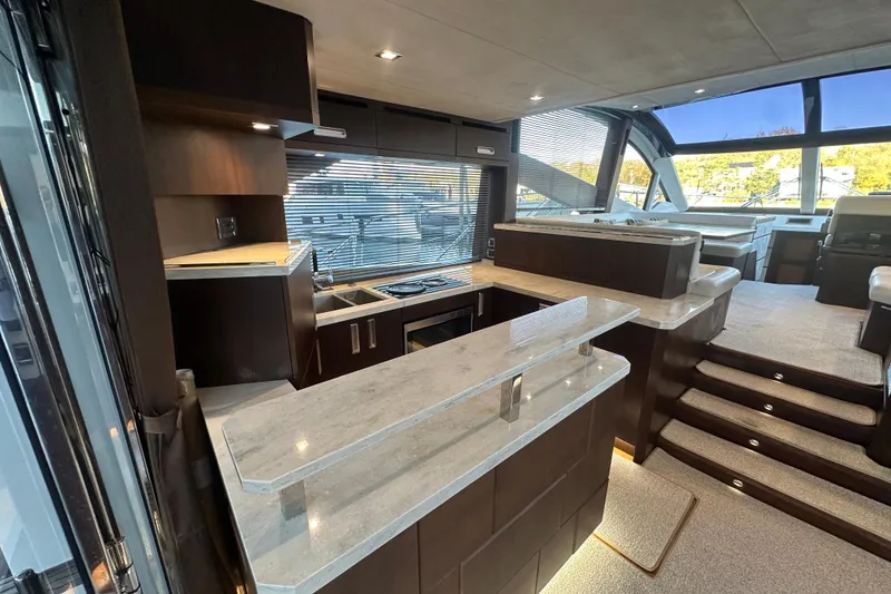 Slide: The Image of Luxurious interior of 2017 Galeon 560 Sky yacht with modern kitchen and seating area. - 3