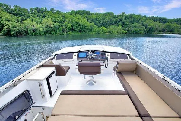 Slide: The Image of 2017 Galeon 560 Sky yacht interior with helm, seating, and scenic water view. - 34
