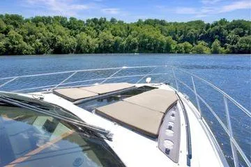 Slide: The Image of Galeon 560 Sky 2017 yacht on a serene lake with lush green forest backdrop. - 37