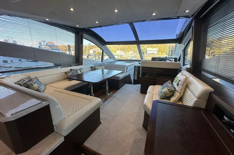 Slide: The Image of Luxurious interior of 2017 Galeon 560 Sky yacht with plush seating and panoramic windows. - 9