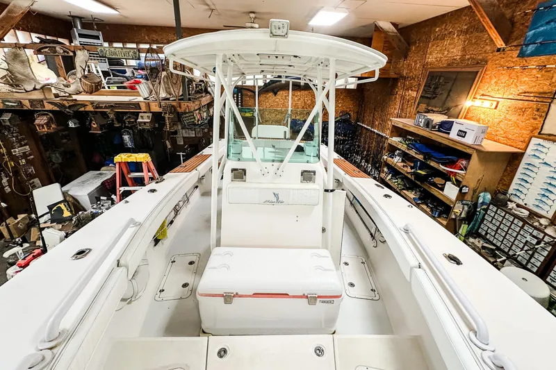 Slide: The Image of 2009 Blue Fin 240 Islander boat in a workshop with fishing gear and tools. - 15