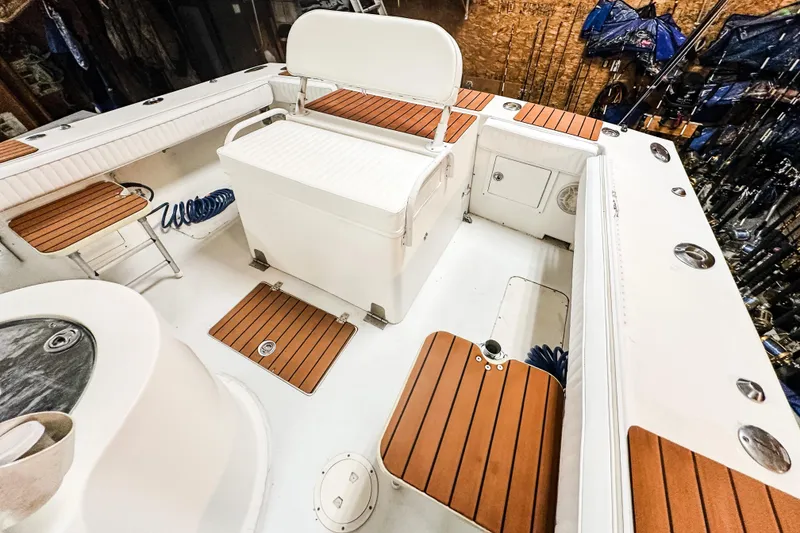 Slide: The Image of 2009 Blue Fin 240 Islander boat interior with wooden accents and seating arrangement. - 18