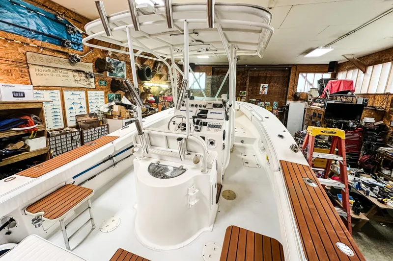 Slide: The Image of 2009 Blue Fin 240 Islander boat in a workshop, featuring wood accents and navigation equipment. - 21