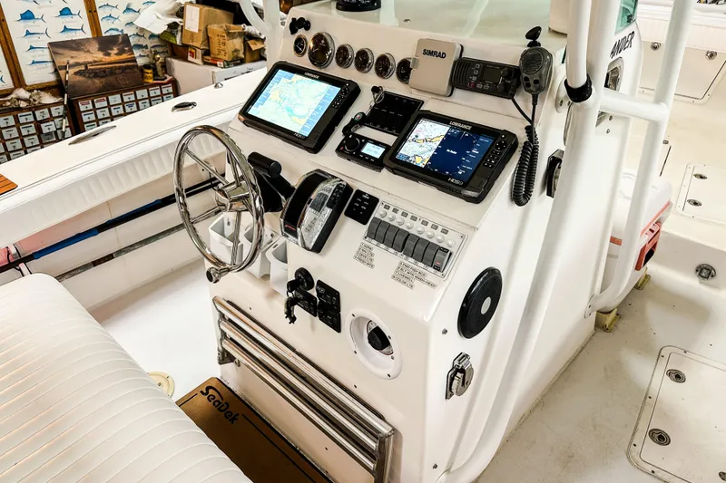 Slide: The Image of 2009 Blue Fin 240 Islander boat console with navigation equipment and controls. - 22
